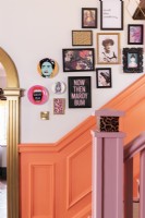 Salon style art display on colourful staircase