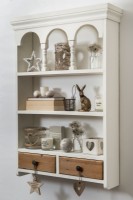 Wall mounted shelf unit displaying ornaments