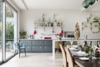 Dining table decorated for Christmas in modern kitchen-diner 