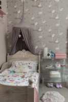 Flamingo wallpaper and wooden bed in childs bedroom