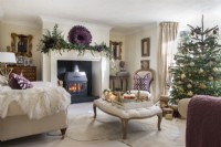 Lit fireplace in classic living room decorated for Christmas