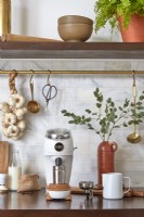 Coffee grinder and utensils on modern kitchen worktop
