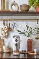Coffee grinder and utensils on kitchen worktop