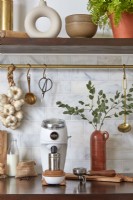 Coffee grinder and utensils on kitchen worktop