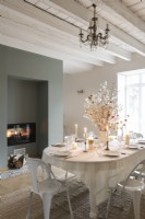 Country dining room with table laid for Christmas dinner