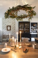 Christmas wreath pendant over wooden country dining table