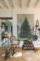 Pet dog on rug in country living room decorated for Christmas