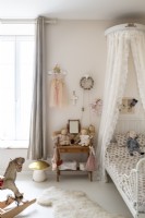 Childrens country bedroom with canopy over bed 