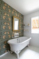 Country bathroom with wallpapered feature wall