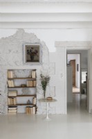 Alcove in exposed stone wall with bookshelves