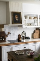 Old portrait painting in country kitchen