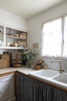 Sink with fabric skirt in rustic country kitchen