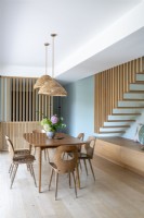 Modern wooden dining room with floating stair case