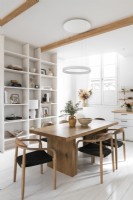 White painted kitchen-diner with wooden furniture 