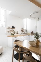 White painted kitchen-diner with wooden furniture