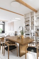 White painted open plan living space with wooden dining table