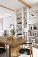 Modern white painted dining room with wooden furniture