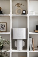 White lamp on moulded shelving unit