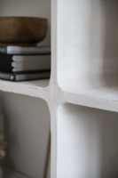 Detail of white moulded shelf unit