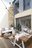 Outdoor dining area and sofa on decked terrace