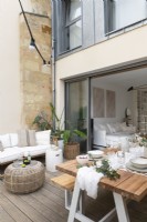 Small decked terrace with modern furniture and dining area