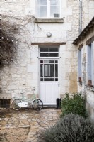 Bicycle outside back door of country house in winter