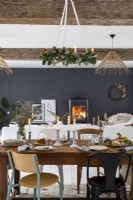 Lit fire and black feature wall in open plan living space at Christmas