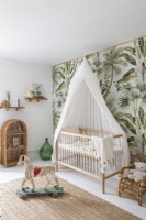 Tropical wallpaper feature wall in baby nursery
