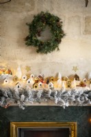 Wreath on stone wall above fireplace decorated for Christmas