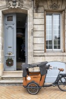 Bicycle with transporter outside classic house