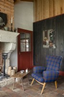 Blue tartan armchair and small coffee table in country living room