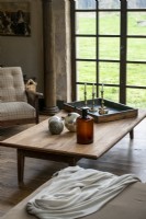 Wooden coffee table in country living room next to French doors