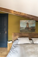 Painting of windmill above bed in country bedroom