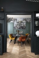 View into dining room through black painted doorway