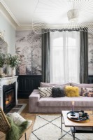Large pink sofa in modern living room with period details