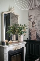 Mirror and flowers on mantelpiece - detail