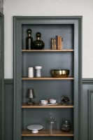 Dark green painted woodwork - shelving in alcove