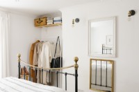 Open closet in a minimalist, contemporary bedroom.