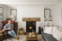 Kati Scalet sitting in her contemporary open plan living room in a Cornish cottage.