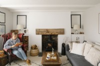 Kati Scalet sitting in her contemporary open plan living room in a Cornish cottage. 