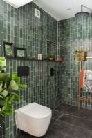 Wet room shower with green tiles 