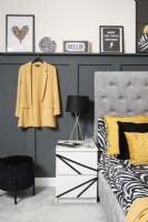 Monochrome and yellow bedside with grey panelling