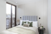 Modern bedroom with floor to ceiling sliding windows and Juliet balcony