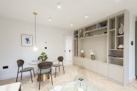 Built in shelving in open plan living space with dining table