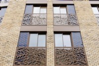 Detail of modern apartment building windows with metal cut out Juliet balconies