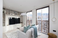 Modern living room with floor to ceiling sliding glass doors and Juliet balconies