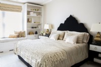 Modern bedroom decorated in white, cream, black and gold colors.