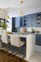 Modern kitchen in blue and white with breakfast bar. 