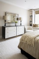 Modern bedroom decorated in white, cream, black and gold colours.