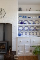 Dresser with blue and white china in white painted living room